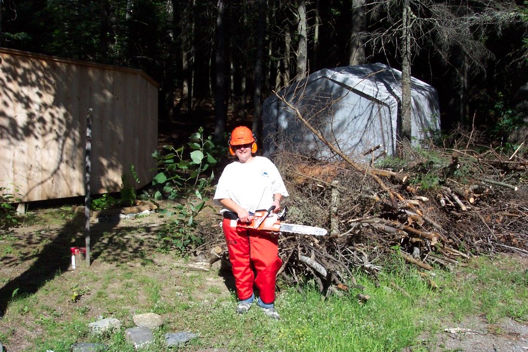 Camp owner holding chainsaw